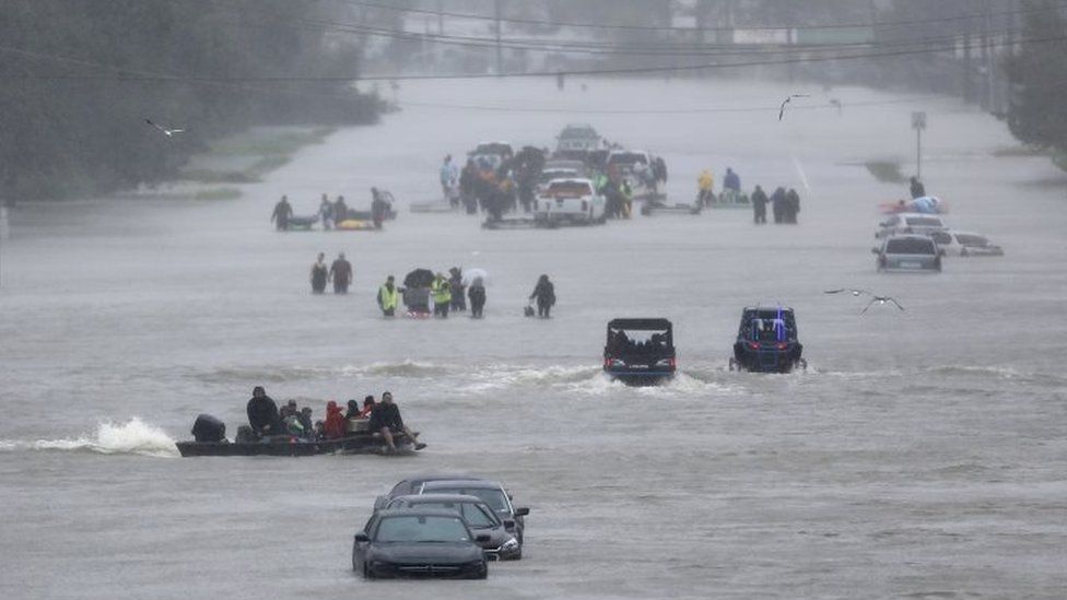 An image showing residents waiting to be rescued from the flood waters of Tropical Storm Harvey