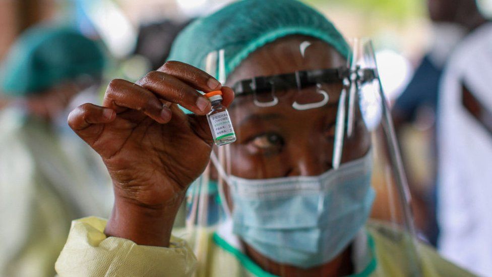 A health worker holds the Sinopharm vaccine before administering it to a patient at Wilkins Infectious Diseases Hospital on February 18, 2021 in Harare, Zimbabwe. Zimbabwe will begin vaccinating against Covid-19 on Thursday, starting with health workers and other essential service personnel. Health professionals and immigration agents working at border posts will get first priority for the jabs, according to a government roll-out plan. (Photo by Tafadzwa Ufumeli/Getty Images)