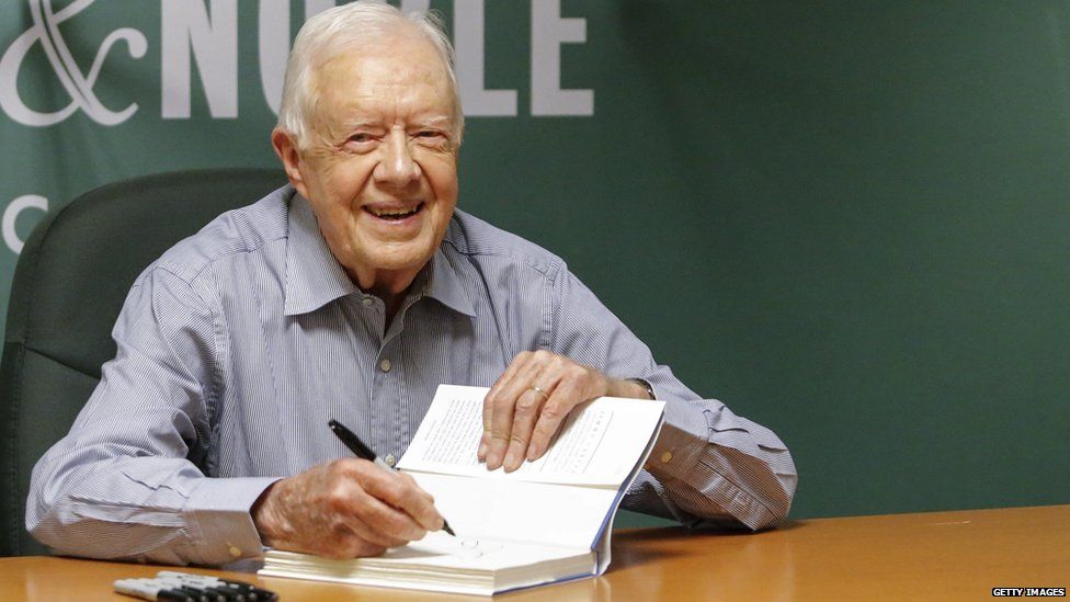 In this July 7, 2015 file photo, former US President Jimmy Carter signs his new Book "A Full Life: Reflections at Ninety" at Barnes & Noble on 5th avenue in New York 7 July 2015