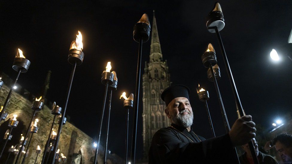The Very Reverend Theo Polyviou of the Greek Orthodox Church of the Holy Transfiguration takes part in the Ceremony of Light procession at Coventry Cathedral ruins, in September