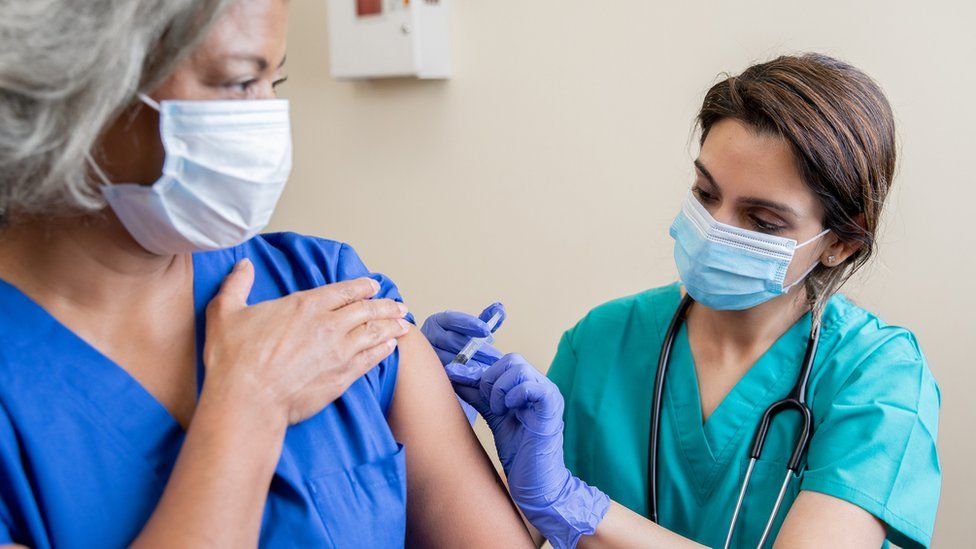 healthworker being vaccinated