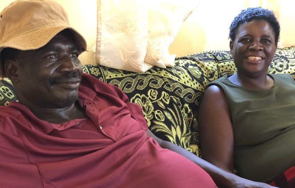 Man in red shirt and woman in green vest