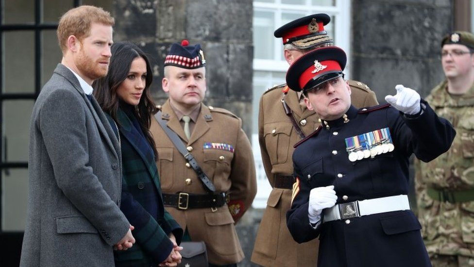 Prince Harry and Meghan Markle meet Sgt David Beveridge (right) before he fires the One o'clock gun at Edinburgh Castle
