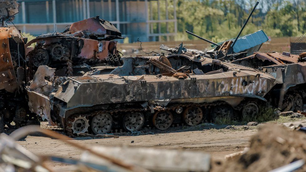 Destroyed Russian military vehicles lie in a garbage dump in Bucha