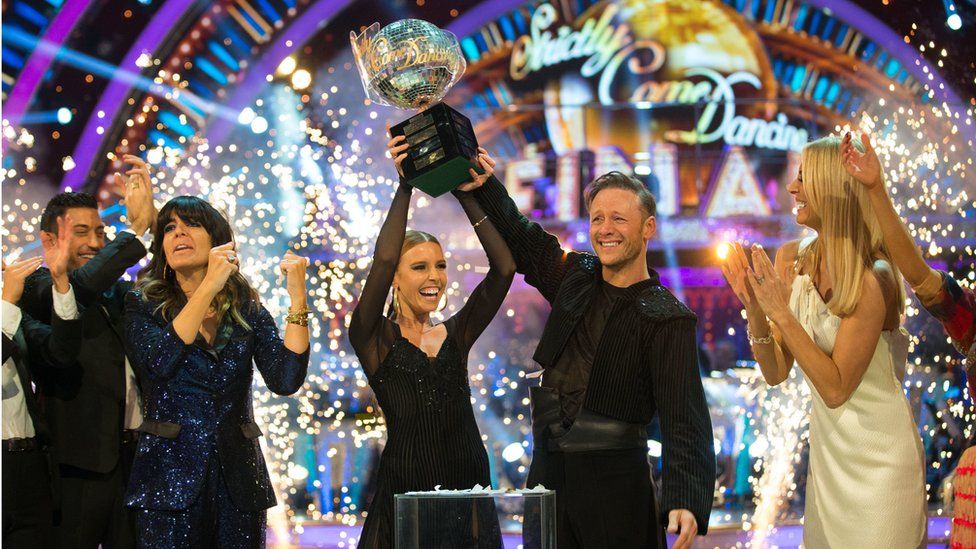 Stacey Dooley and Kevin Clifton lift the Strictly glitterball trophy