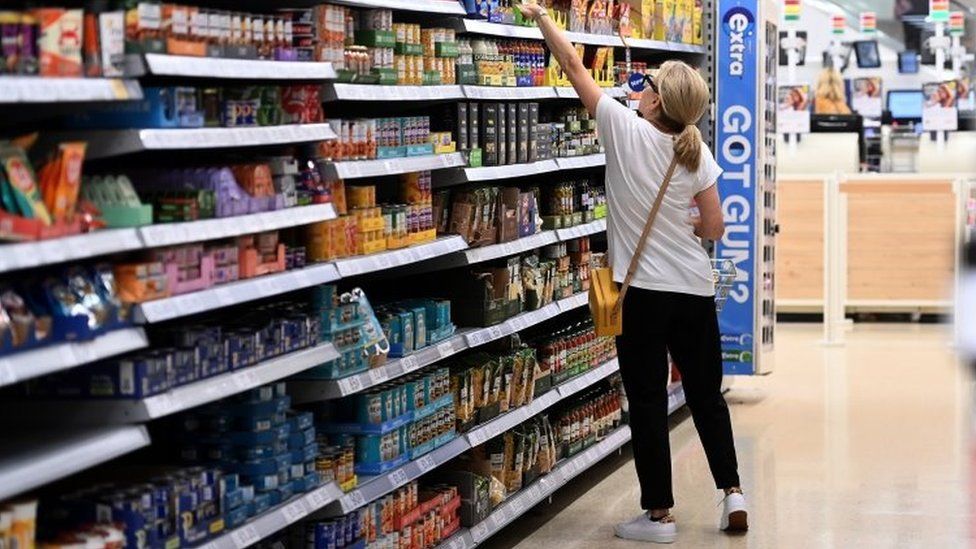 A customer shops at a supermarket in London