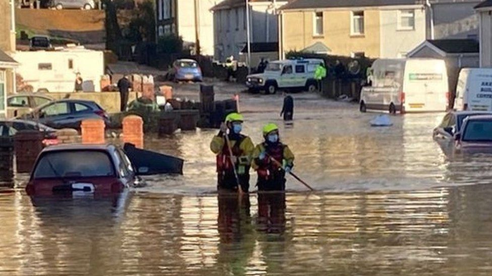 Firefighters waded through water up to their thighs amidst reports of evacuated homes in Skewen
