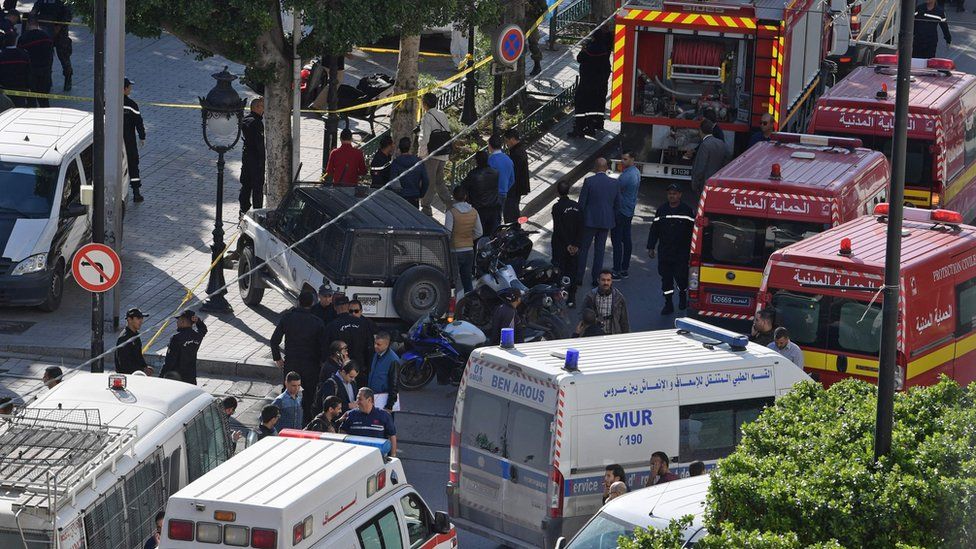 A picture taken on October 29, 2018, shows police and firemen gathering at the site of a suicide attack in the centre of the Tunisian capital Tunis