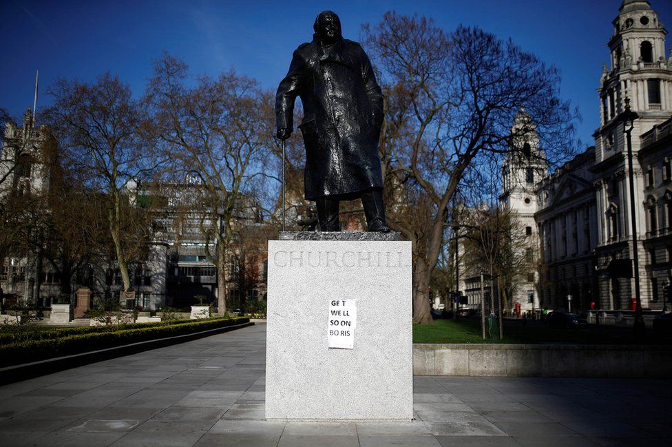 A "get well soon" message is seen attached to a statue of Sir Winston Churchill