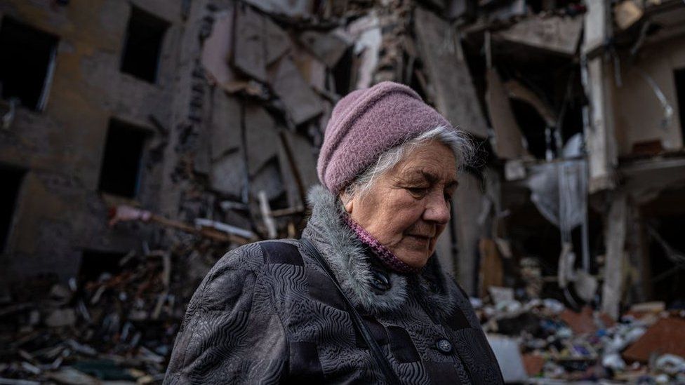 A woman looks at the buildings she used to live in until they were destroyed by a Russian rocket attack in Kramatorsk, Ukraine