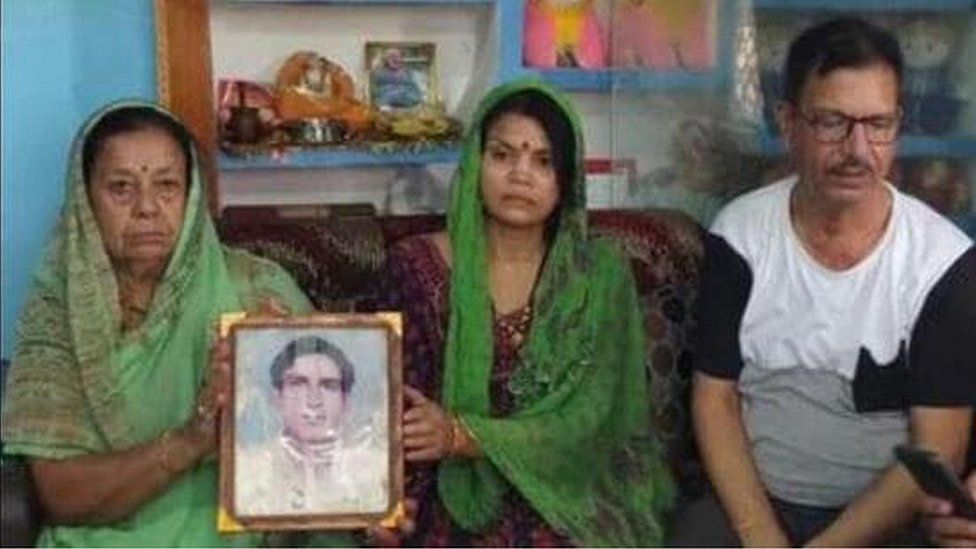Chandrashekhar Harbola's family holds up a photo of the missing soldier