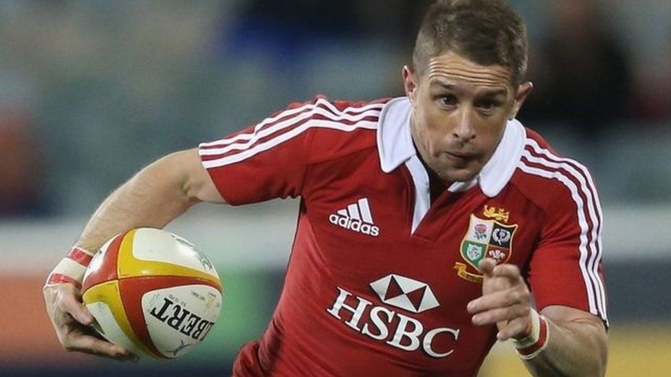Former rugby international Shane Williams running with a rugby ball while in action for the British Lions