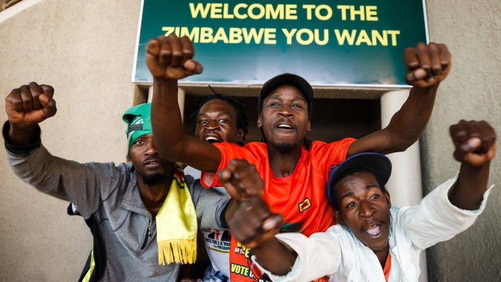 Supporters of Zimbabwe's ruling ZANU-PF party react after Zimbabwe's top court threw out an opposition bid to overturn presidential election results in favour of the ZANU-PF candidate on August 24, 2018, in Harare.