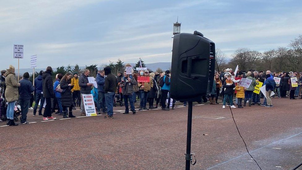 Anti-Covid passport demonstrators gather at Stormont on 13 December