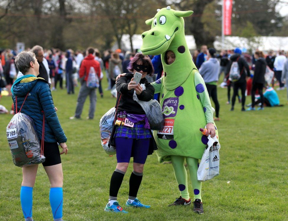 Competitors in fancy dress take a selfie before the London Marathon