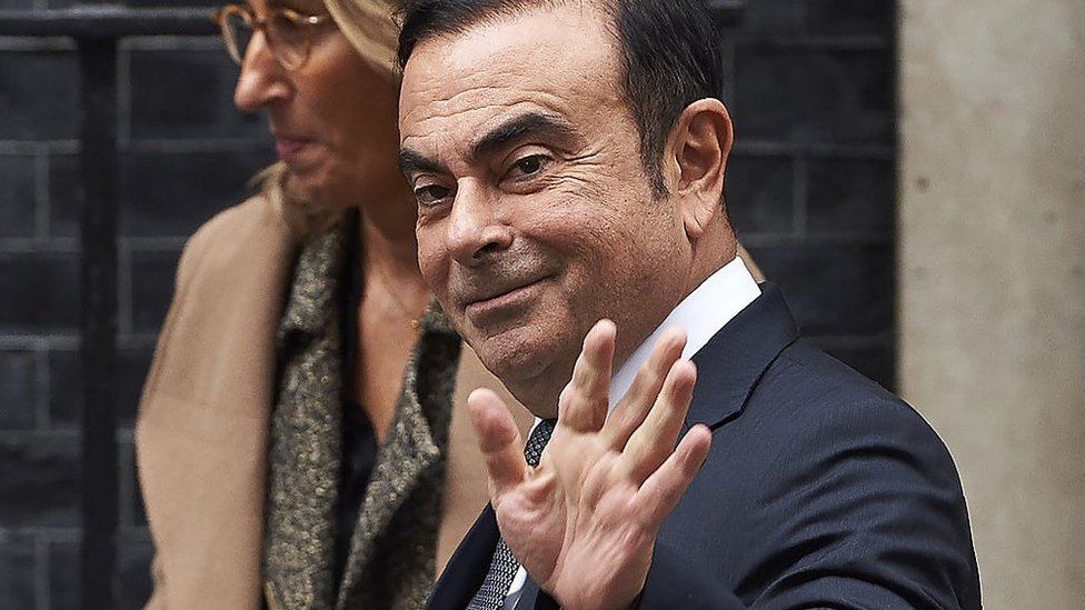 Nissan CEO Carlos Ghosn waves as he leaves No 10 Downing Street in central London on October 14, 2016, after meeting with British Prime Minister Theresa May