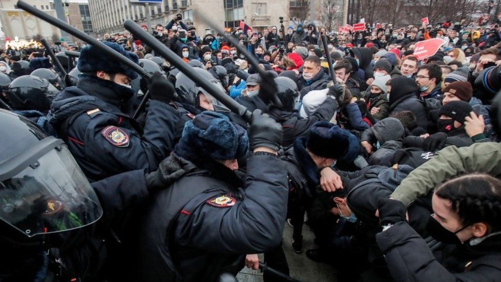 Law enforcement officers clash with participants during a rally in support of jailed Russian opposition leader Alexei Navalny in Moscow