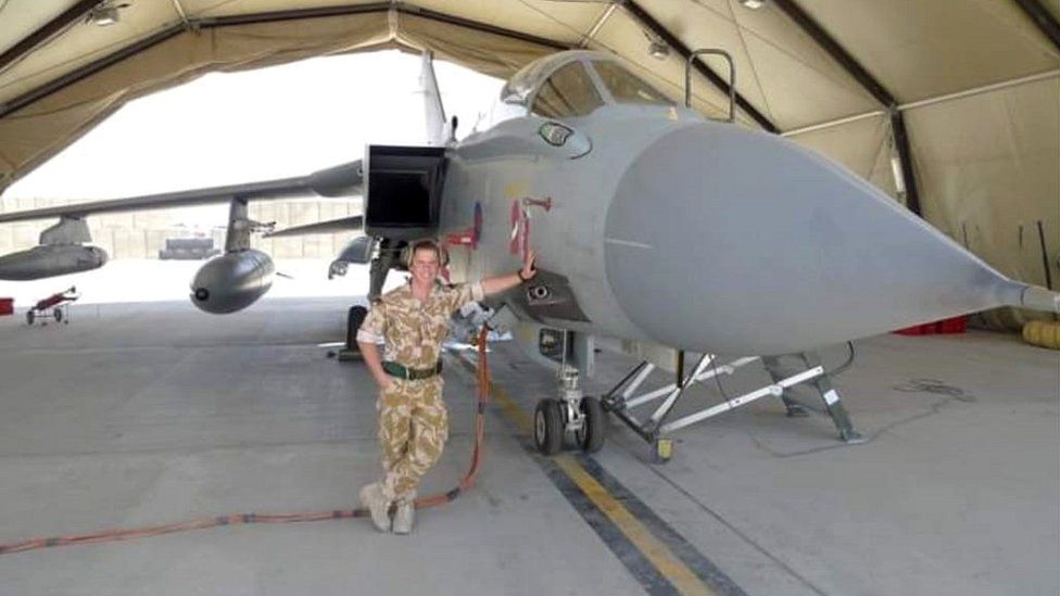 Sean in the Royal Marines next to aircraft