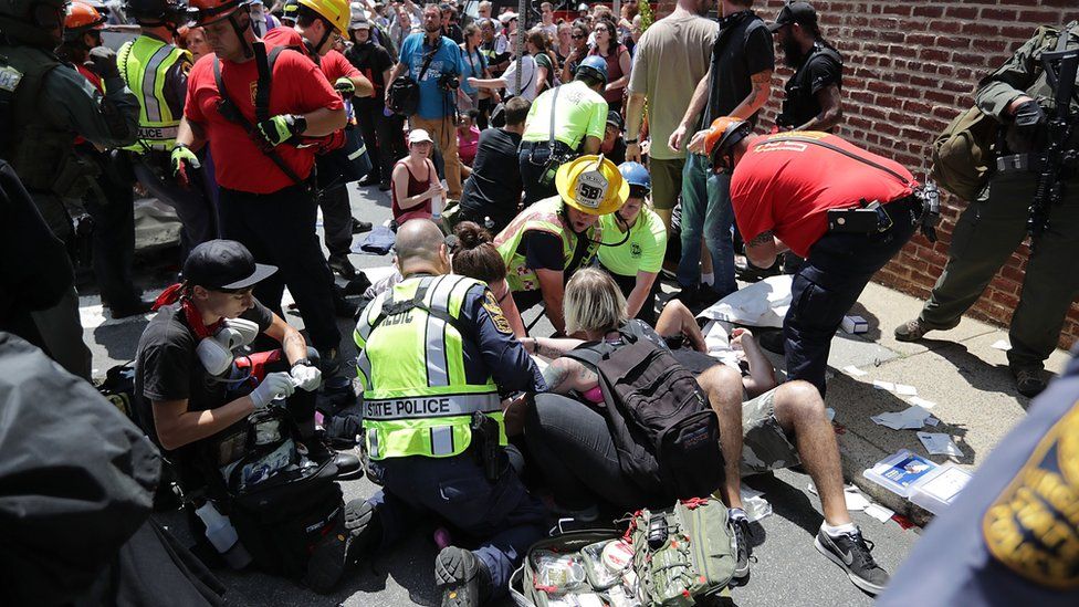 Emergency services treat the injured after a car drove into anti-fascist demonstrators in Charlottesville