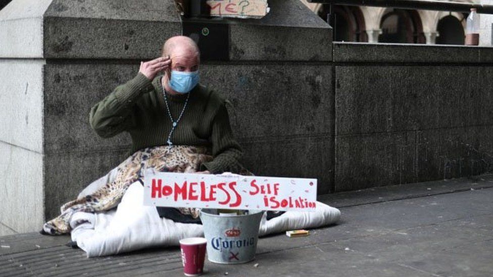 A homeless man wearing a protective face mask is seen in Westminster, as the spread of the coronavirus disease (COVID-19) continues, London, Britain