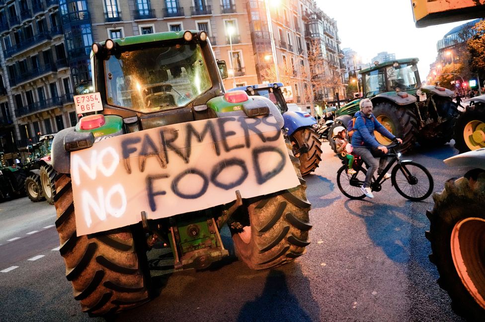 A placard on a tractor reads 'No farmers, no food' during a protest by farmers in downtown Barcelona, Spain, 7 February 2024