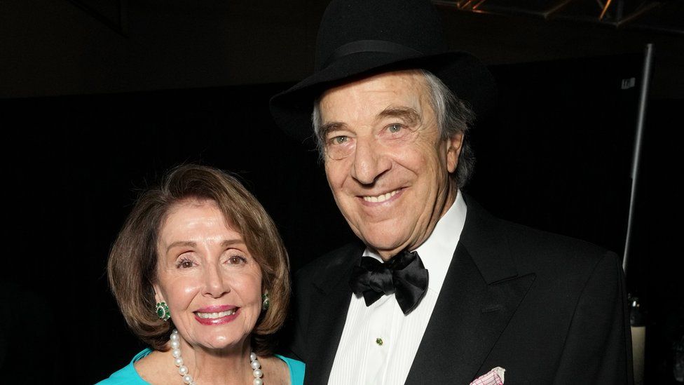 Paul and Nancy Pelosi pose for a photo at an awards show in February 2023