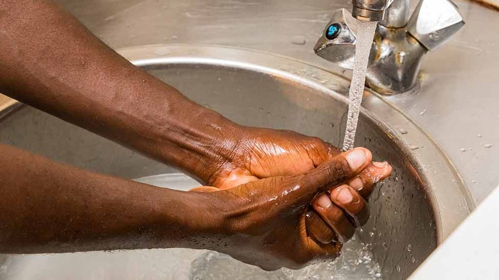 Black person washing hands