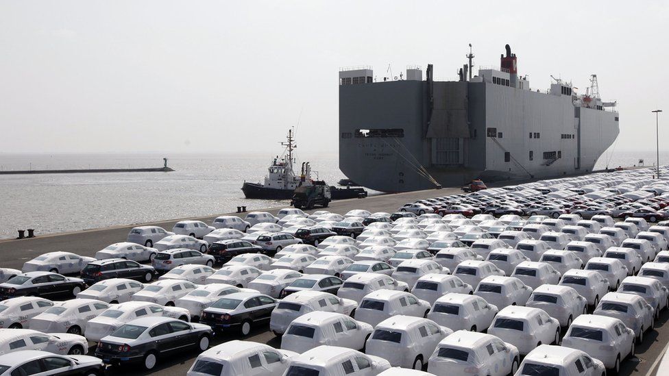 VW cars wait to get loaded onto transport ships at the Volkswagen car factory Emden