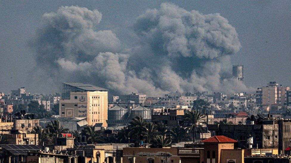 Picture taken from Rafah shows smoke billowing over Khan Yunis in the southern Gaza Strip during Israeli bombardment on 17 January 2024