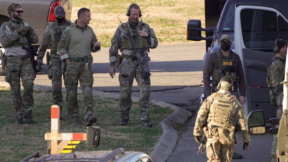 Law enforcement officers search the property of a possible person of interest in Antioch, near Nashville. Photo: 26 December 2020
