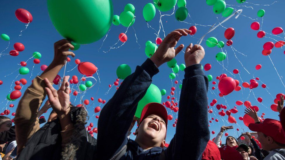 Children releasing red and green balloons in Marrakesh, Morocco - Wednesday 20 November 2019