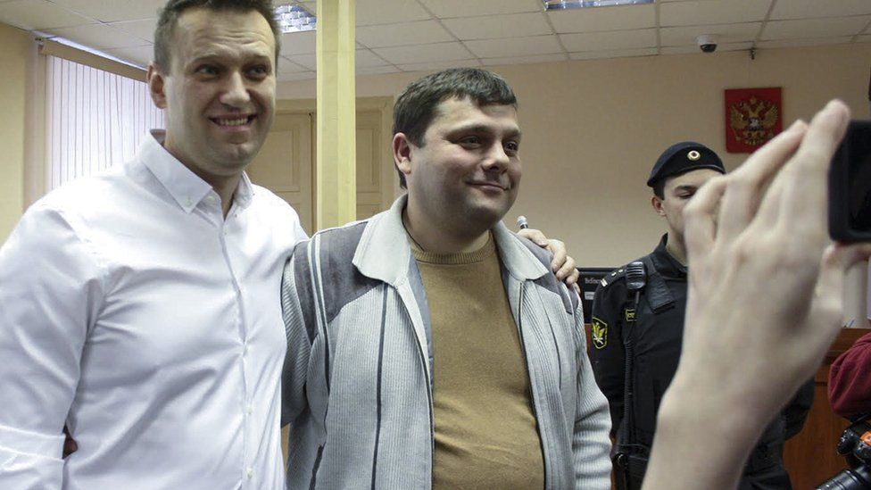 Russian opposition leader Alexei Navalny, left, poses with his former colleague Pyotr Ofitserov in the court in Kirov, Russia, Wednesday, Feb. 8, 2017