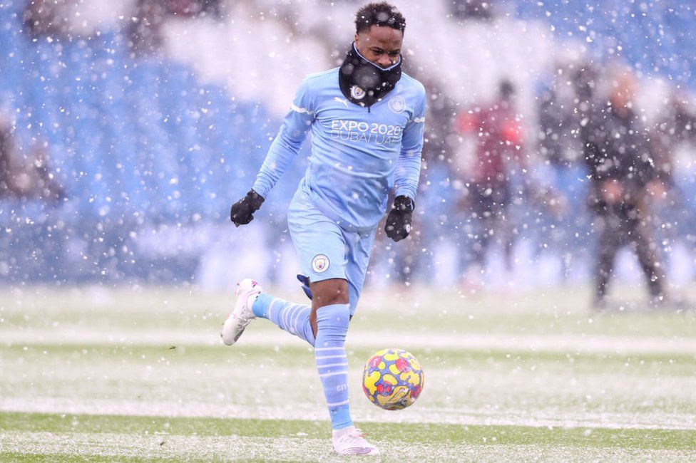 Raheem Sterling of Manchester City warms up in the snow prior to the Premier League match between Manchester City and West Ham United at Etihad Stadium