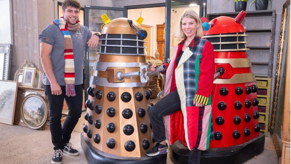 Two Daleks with staff wearing items due to be auctioned