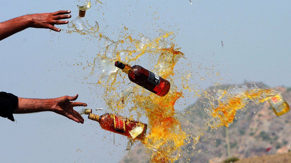 Pakistani Frontier Corps personal brake liquor bottles in a ceremony in the Shahkas area in Pakistan, on 26 June, 2013