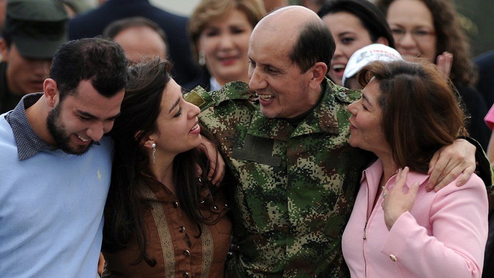 Former Revolutionary Armed Forces of Colombia (FARC) hostage Gen Luis Herlindo Mendieta (2nd R) walks with his family upon arrival in Bogota on June 14, 2010.