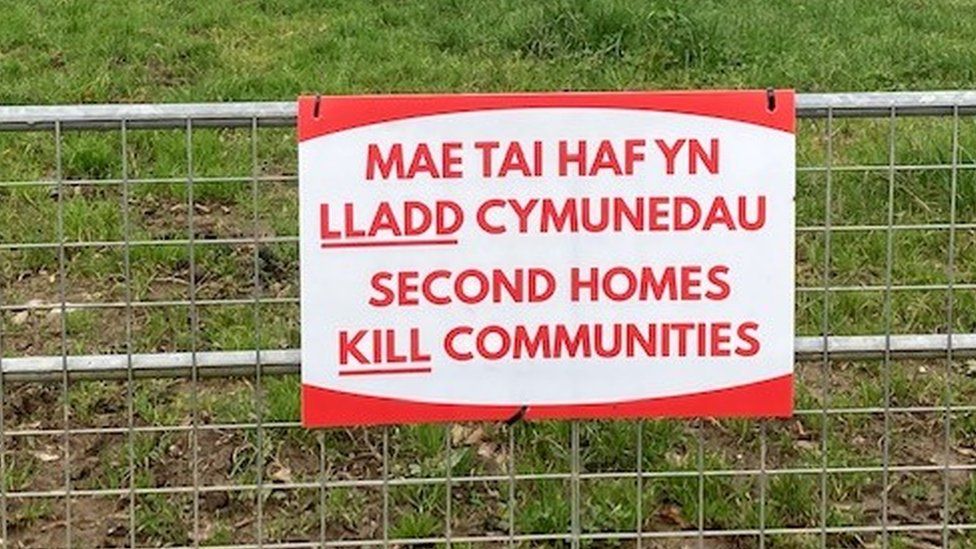 Second homes kill communities sign