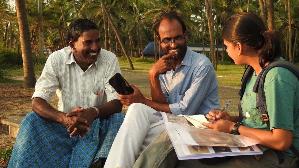 Researcher talking to locals