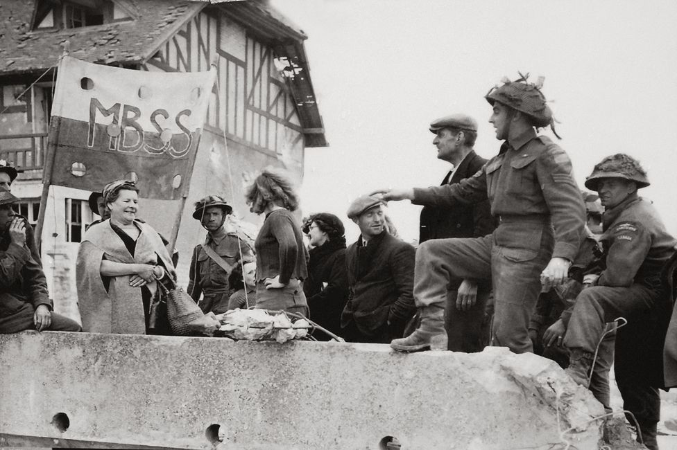 Canadian troops meet the townspeople of Bernieres-sur-Mer