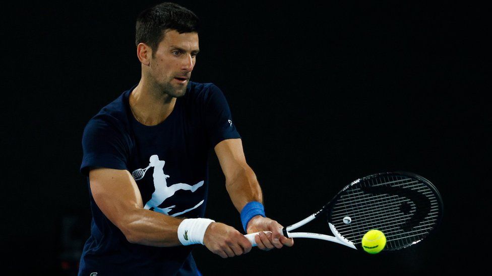Novak Djokovic of Serbia plays a backhand during a practice session ahead of the 2022 Australian Open at Melbourne Park on January 14, 2022 in Melbourne, Australia