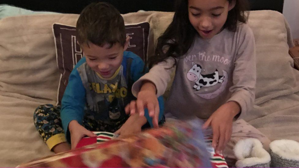 Children Isaac and Olivia opening their boxes