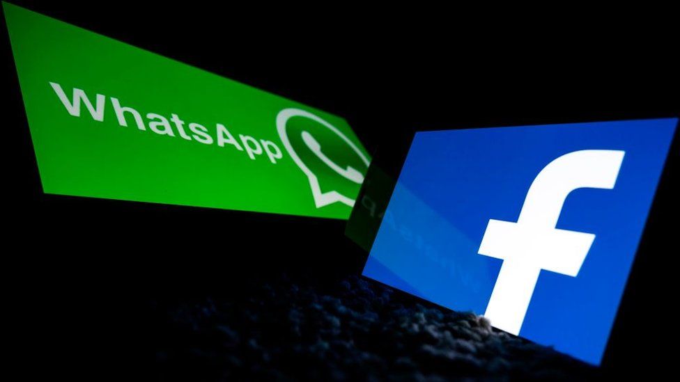 The WhatsApp and Facebook logots are seen against a dark background, framed by phone screen bezels