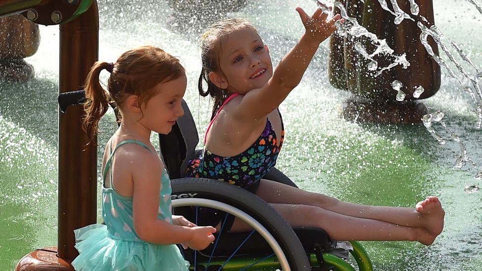 Two girls enjoying a fountain