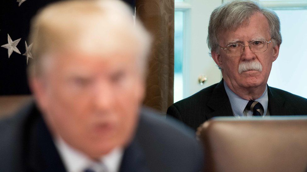 John Bolton (right) looks at Donald Trump. File photo