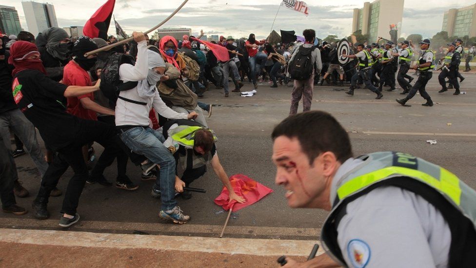 Protesters clash with police outside the National Congress building
