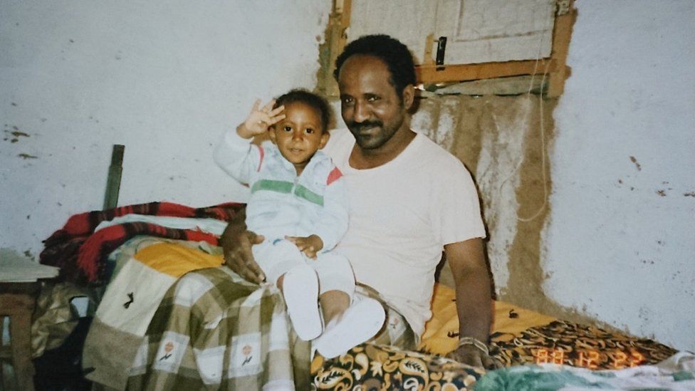 Ibrahim Sherifo as a baby with his father