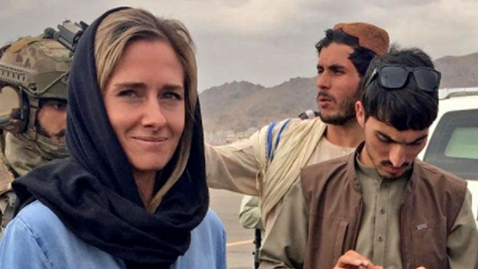 Kiwi journalist Charlotte Bellis with Taliban officials on their iPhones after surveying Hamid Karzai International Airport.