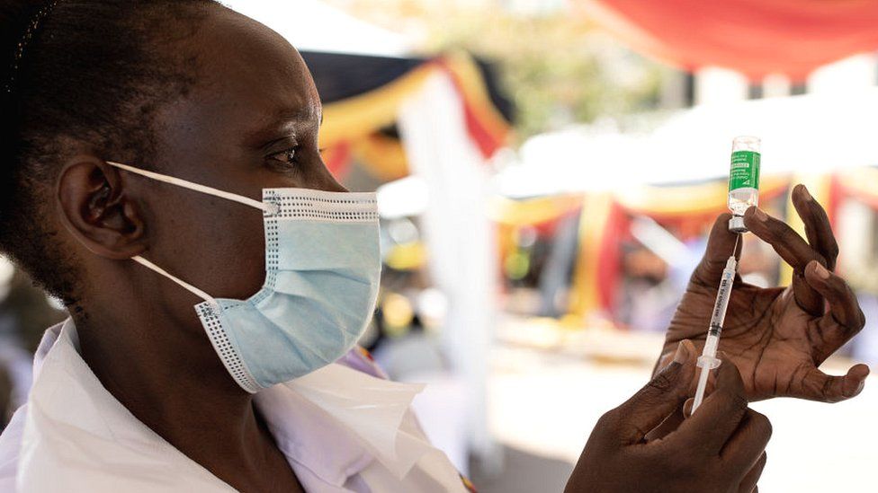 A Ugandan nurse draws a vaccine dose in Kampala