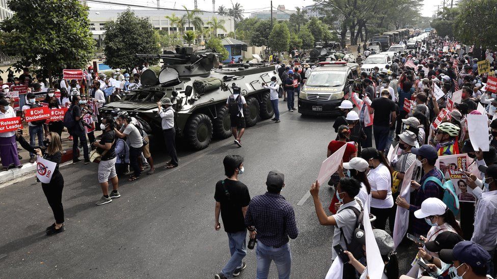 Demonstrators lined the street where soldiers and armoured vehicles were deployed during a protest outside the Central Bank in Yangon, Myanmar, 15 February 2021