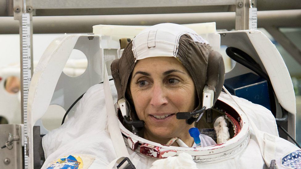 Astronaut Nicole Stott participates in an Extravehicular Mobility Unit (EMU) spacesuit fit check in the Space Station Airlock Test Article (SSATA) in the Crew Systems Laboratory at NASA's Johnson Space Centre